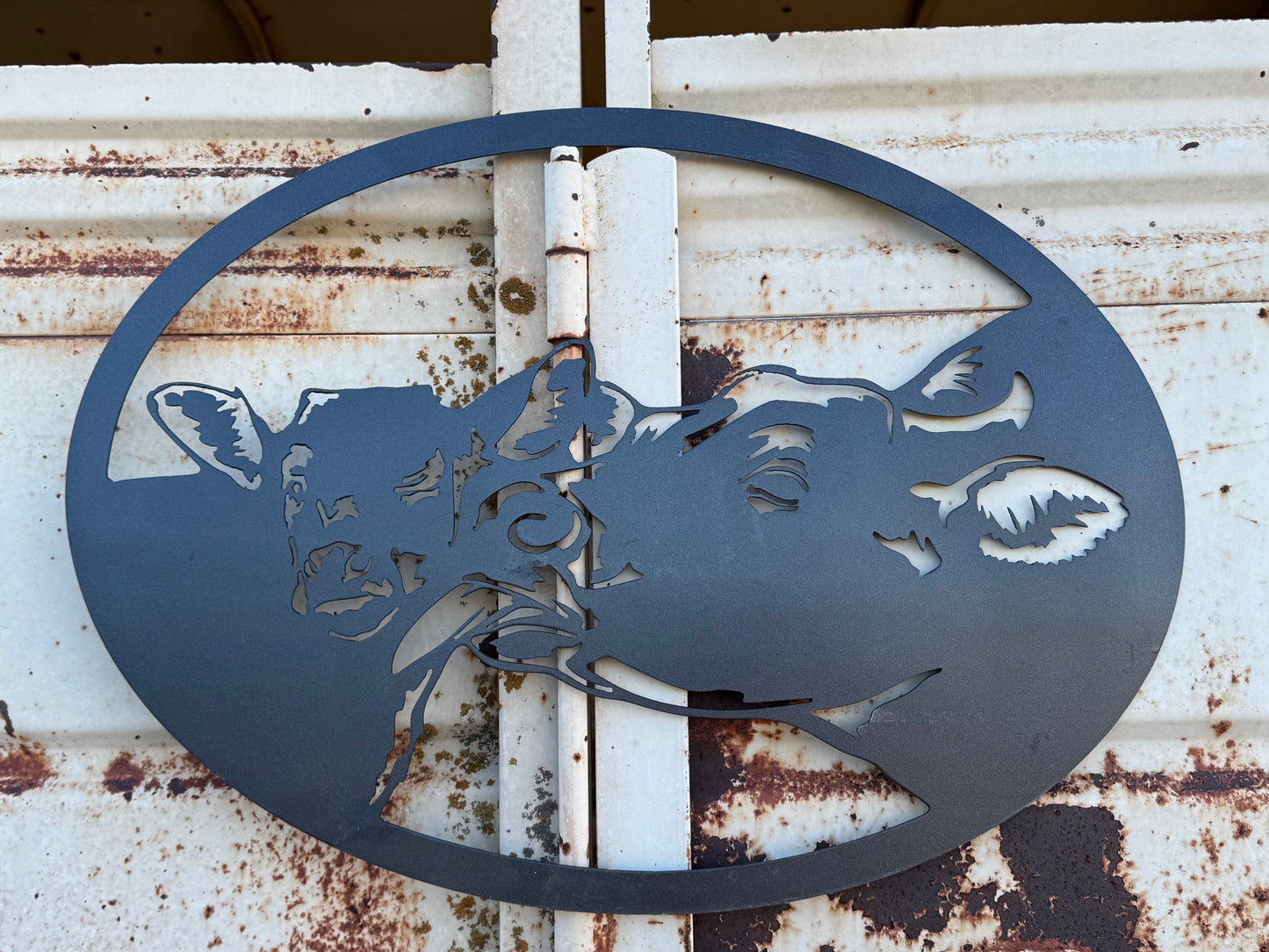 Metal mama and baby cow sign